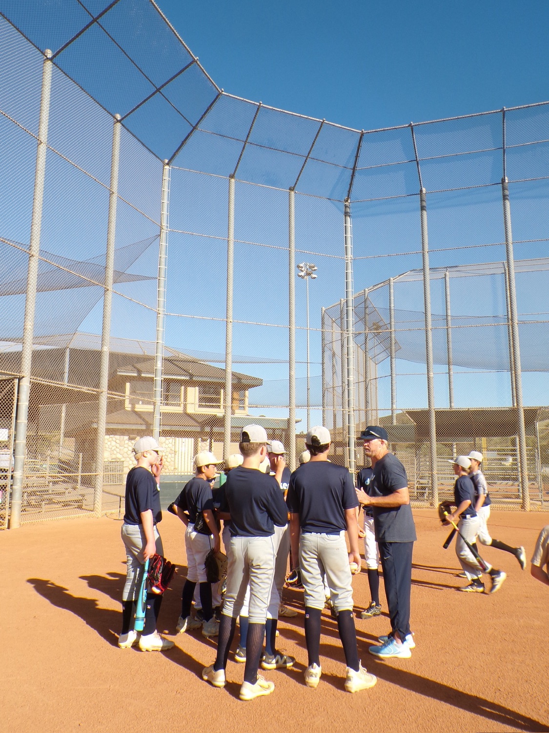 Coach Seth instructing Dukes players on the field